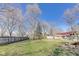 Large backyard featuring green grass and tall trees at 5330 Manker St, Indianapolis, IN 46227