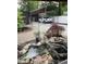 Backyard featuring a pond, a car port, and a trampoline, offering relaxation and functionality at 5330 Manker St, Indianapolis, IN 46227