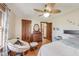 Bedroom featuring hardwood floors, decorative ceiling fan, and a comfortable papasan chair at 5330 Manker St, Indianapolis, IN 46227