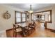 Open concept dining room featuring hardwood floors, adjacent living space, and stylish lighting fixtures at 5330 Manker St, Indianapolis, IN 46227