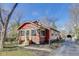 Charming exterior view of a red brick and wood home, showcasing its cozy curb appeal and fenced yard at 5330 Manker St, Indianapolis, IN 46227