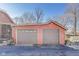 Two-car garage with gray doors and a classic red brick exterior under a clear sky at 5330 Manker St, Indianapolis, IN 46227