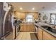 Well-lit kitchen featuring stainless steel appliances and light wood cabinets at 5330 Manker St, Indianapolis, IN 46227