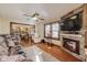 Open-concept living room with a stone fireplace, hardwood floors, seamless transition to the dining area and kitchen at 5330 Manker St, Indianapolis, IN 46227