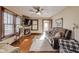 Cozy living room featuring a stone fireplace, hardwood floors, and a comfortable sofa, perfect for relaxation at 5330 Manker St, Indianapolis, IN 46227
