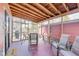 Relaxing screened-in porch with wooden ceiling, table, and chairs at 5330 Manker St, Indianapolis, IN 46227