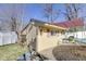 Charming yellow shed with a vintage lantern and a cozy window under a blue sky at 5330 Manker St, Indianapolis, IN 46227