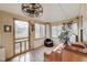 Bright sunroom showcasing natural light, tiled floor, view of front yard and decorative accents for a cozy ambiance at 5330 Manker St, Indianapolis, IN 46227