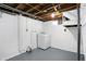 Basement laundry area with white washer and dryer against painted concrete block walls at 5350 E 20Th Pl, Indianapolis, IN 46218