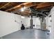 Unfinished basement featuring painted concrete walls and exposed wooden ceiling joists at 5350 E 20Th Pl, Indianapolis, IN 46218