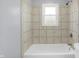 An updated bathroom with tiled shower and tub at 5350 E 20Th Pl, Indianapolis, IN 46218
