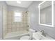 A bathroom featuring tile details, a lighted mirror and modern fixtures at 5350 E 20Th Pl, Indianapolis, IN 46218