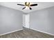 This simple bedroom features a ceiling fan, wood-look floors, and a closet at 5350 E 20Th Pl, Indianapolis, IN 46218
