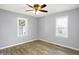 A simple, light-filled bedroom with a ceiling fan and wood-look flooring at 5350 E 20Th Pl, Indianapolis, IN 46218