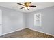 This simple bedroom has a ceiling fan, wood-look floors and a window view at 5350 E 20Th Pl, Indianapolis, IN 46218
