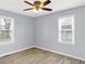An empty bedroom with two windows, ceiling fan, and wood-look flooring at 5350 E 20Th Pl, Indianapolis, IN 46218