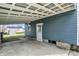Open carport attached to a blue house, overlooking a grassy yard with an outbuilding at 5350 E 20Th Pl, Indianapolis, IN 46218