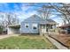 Charming blue home featuring a covered carport and a cozy front porch area at 5350 E 20Th Pl, Indianapolis, IN 46218