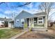 Charming blue home with a covered carport and a cozy front porch at 5350 E 20Th Pl, Indianapolis, IN 46218