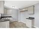 An updated kitchen features gray cabinets, dark countertops, and wood-look floors at 5350 E 20Th Pl, Indianapolis, IN 46218