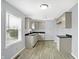 A bright kitchen features gray cabinets, dark countertops, and wood-look floors at 5350 E 20Th Pl, Indianapolis, IN 46218