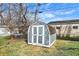 Well-maintained shed in a grassy backyard with a mix of bare and leafy trees at 5350 E 20Th Pl, Indianapolis, IN 46218