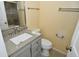 Bathroom with a white vanity, granite countertop, modern fixtures, and toilet at 553 N Traub Ave, Indianapolis, IN 46222
