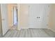 This bedroom has light-colored flooring, a closet, and doors to other rooms at 553 N Traub Ave, Indianapolis, IN 46222