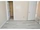This bedroom has neutral-colored walls, light-colored flooring, with access to bathroom and closet at 553 N Traub Ave, Indianapolis, IN 46222