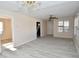 Bright living room featuring new laminate flooring, ceiling fan, multiple windows and chandelier at 553 N Traub Ave, Indianapolis, IN 46222