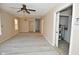 Open concept living room with new laminate flooring, ceiling fan and multiple windows at 553 N Traub Ave, Indianapolis, IN 46222