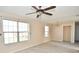 Spacious living room with new laminate flooring, ceiling fan, multiple windows and chandelier at 553 N Traub Ave, Indianapolis, IN 46222