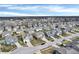 Detailed aerial view of a modern neighborhood featuring neatly arranged homes, cul-de-sacs and a picturesque pond at 5540 Arrowgrass Ct, Noblesville, IN 46062