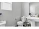 Functional half-bath features a pedestal sink, toilet, and minimalist design at 5540 Arrowgrass Ct, Noblesville, IN 46062