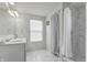 Bright bathroom featuring a double sink vanity, framed mirror and tiled shower and floors at 5540 Arrowgrass Ct, Noblesville, IN 46062