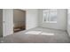 Bright bedroom with neutral carpet, ample natural light from two windows, and a view of an open doorway at 5540 Arrowgrass Ct, Noblesville, IN 46062