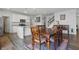 Dining room with modern cabinetry, a staircase, and dark wood table and chairs at 5540 Arrowgrass Ct, Noblesville, IN 46062