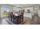 Dining room area with light cabinets, wood-look floors, and sliding glass door to backyard at 5540 Arrowgrass Ct, Noblesville, IN 46062