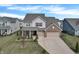 Charming two-story home features a two-car garage, brick accents, and a well-manicured front lawn at 5540 Arrowgrass Ct, Noblesville, IN 46062