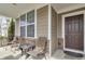 Inviting front porch with seating area and large windows providing ample natural light at 5540 Arrowgrass Ct, Noblesville, IN 46062