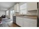 Kitchen featuring stainless steel appliances, light cabinets, stone countertops, and a backyard view at 5540 Arrowgrass Ct, Noblesville, IN 46062