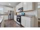 Modern kitchen showcases white cabinets, stainless steel appliances, and wood flooring at 5540 Arrowgrass Ct, Noblesville, IN 46062