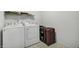 A laundry room features a washer, a dryer, and suitcases at 5540 Arrowgrass Ct, Noblesville, IN 46062