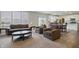 Open-concept living space with neutral carpeting, modern furniture, and natural light at 5540 Arrowgrass Ct, Noblesville, IN 46062