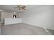 Open concept living room with a ceiling fan and carpeted floors at 5540 Arrowgrass Ct, Noblesville, IN 46062