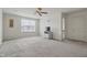 Bright living room with carpet, ceiling fan, and view of backyard at 5540 Arrowgrass Ct, Noblesville, IN 46062