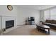 Bright living room with a fireplace, plenty of natural light, and comfortable seating at 5540 Arrowgrass Ct, Noblesville, IN 46062