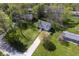Lush landscaping surrounds this beautiful home featuring a concrete driveway and mature trees at 5836 Andover Rd, Indianapolis, IN 46220