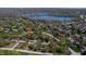 Aerial view of a house surrounded by mature trees, located near a lake with a red pin at 5836 Andover Rd, Indianapolis, IN 46220