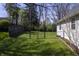 Fenced backyard with lush green grass and a gate, perfect for outdoor entertaining at 5836 Andover Rd, Indianapolis, IN 46220